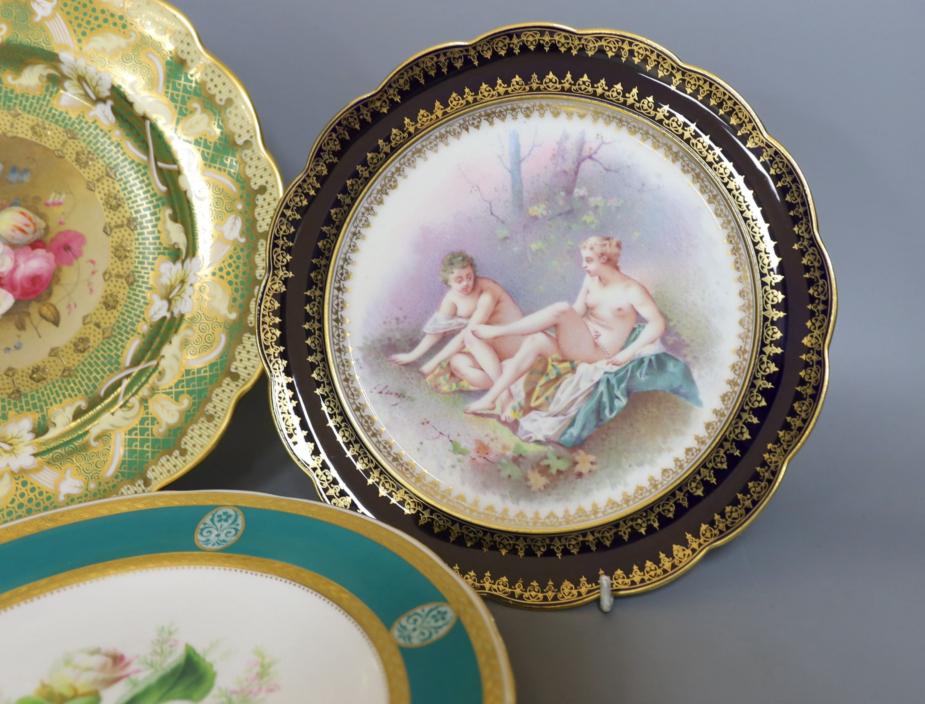 Two 19th century English porcelain flower painted plates, one by Minton and a continental porcelain plate painted with bathers by E Laurent (3)